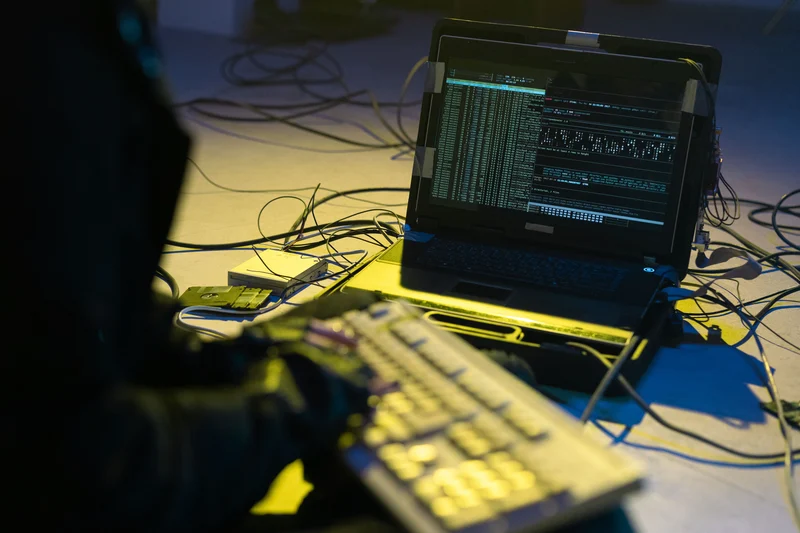 A person programming on a laptop